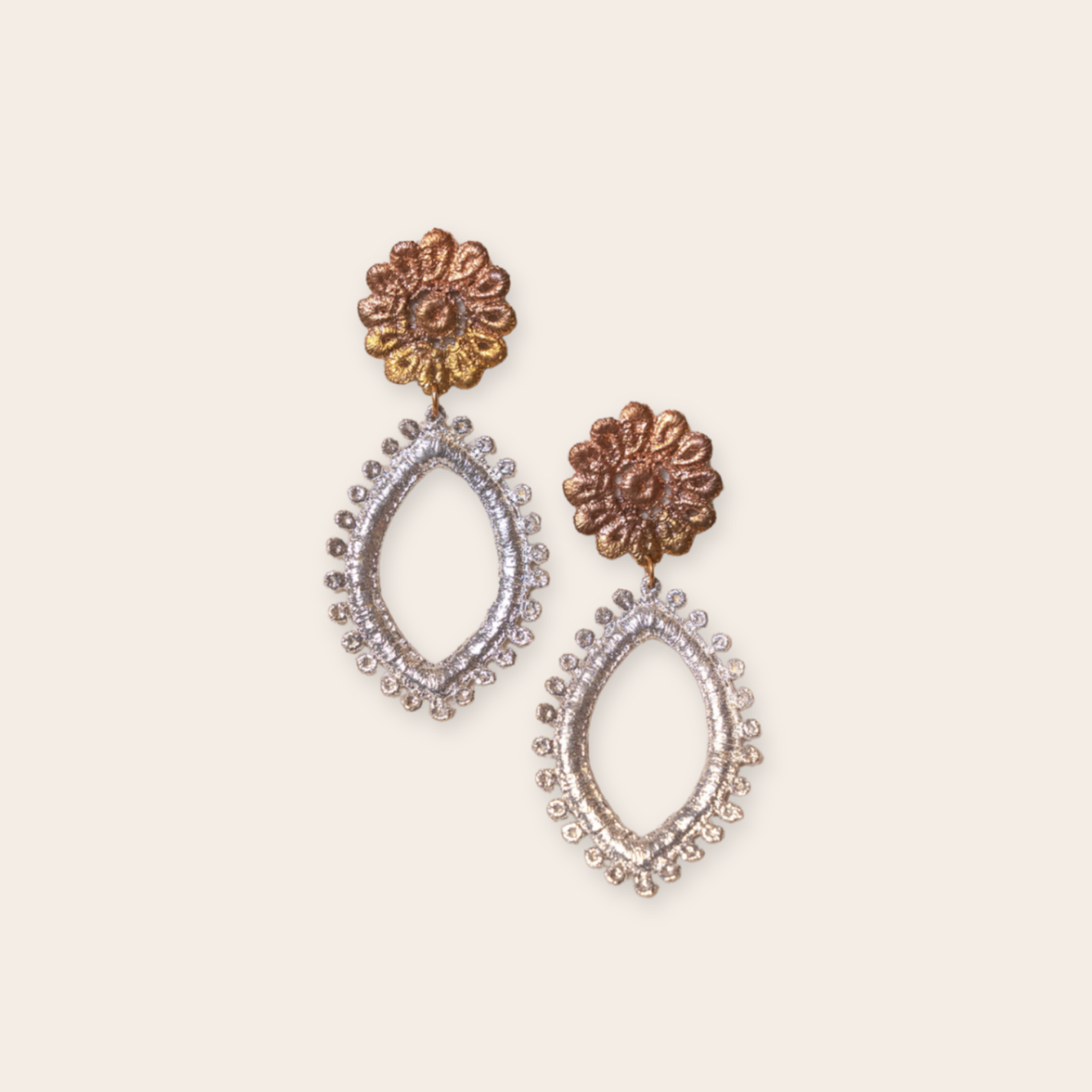 silver and bronze flower drop